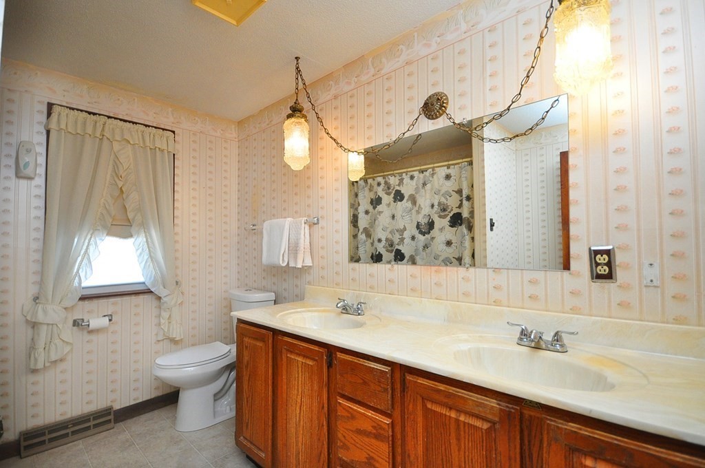 252 Sunrise Terrace Springfield, MA 01119 - Photo 21 of 41 a bathroom with a granite countertop sink toilet and a mirror