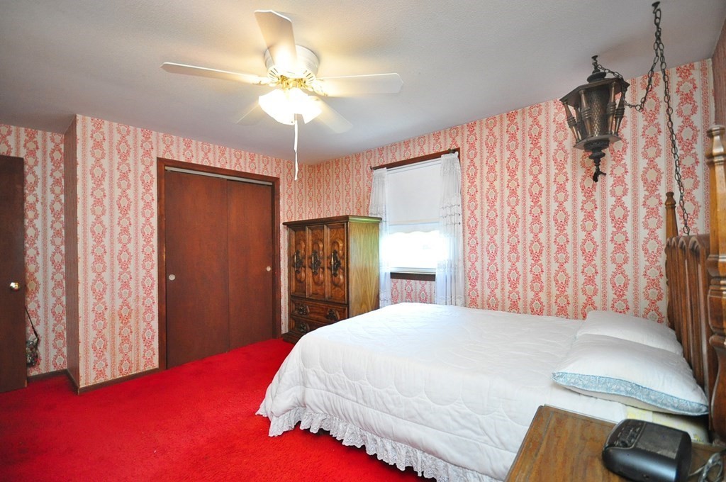 252 Sunrise Terrace Springfield, MA 01119 - Photo 24 of 41 a bedroom with a bed and a chandelier