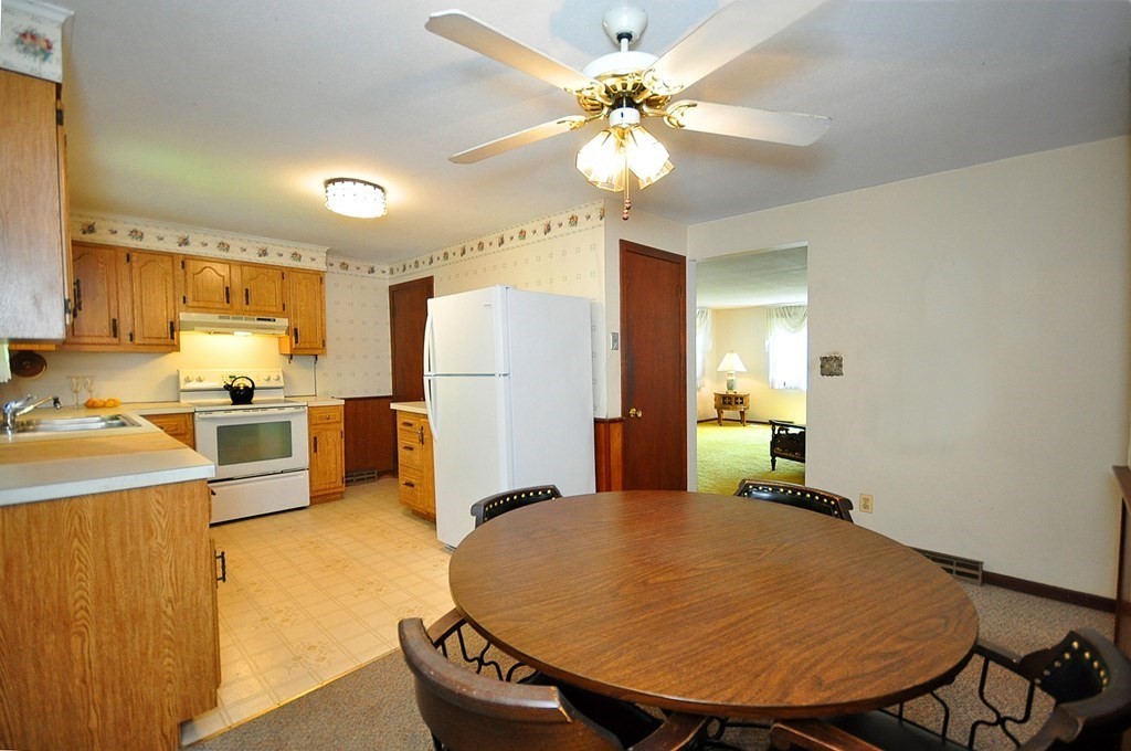 252 Sunrise Terrace Springfield, MA 01119 - Photo 8 of 41 a kitchen with stainless steel appliances a refrigerator a stove a sink dishwasher with a dining table and chairs