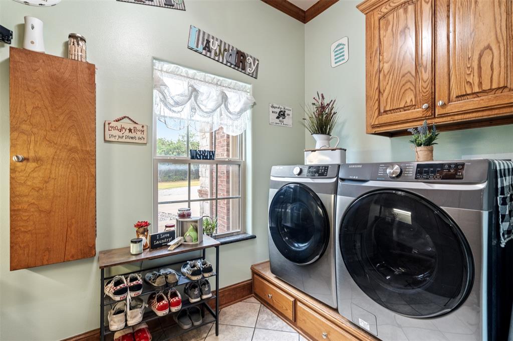 145 County Road 2327 Decatur, TX 76234 - Photo 27 of 40 Laundry room with built in appliance riser with added storage.