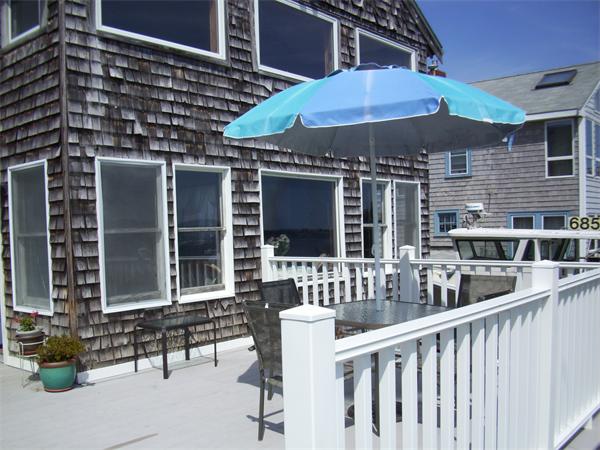 119 Edgewater Road, Unit WATERFRONT Hull, MA 02045 - Photo 17 of 21 a couple of table and chairs under an umbrella
