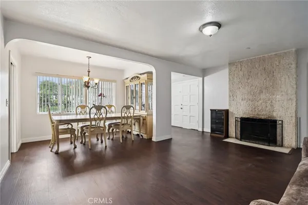 an open kitchen with furniture and fireplace