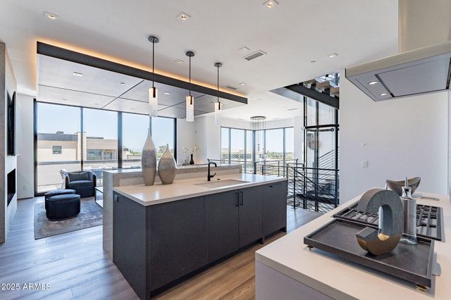a kitchen with a sink and a stove next to a large window