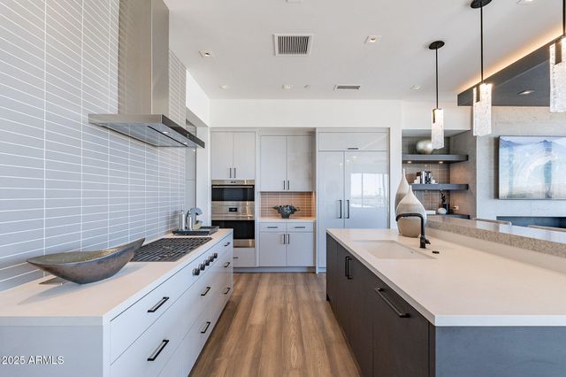 a kitchen with a sink stove and cabinets