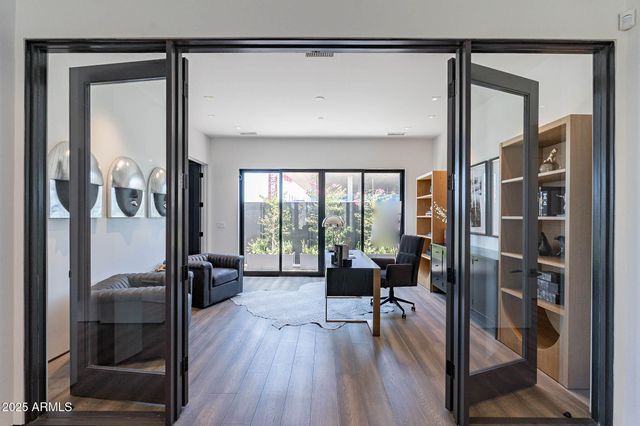 a living room with furniture and a floor to ceiling window