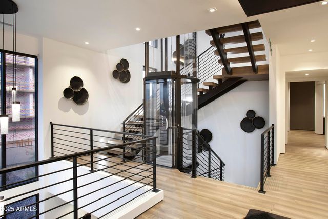 a view of entryway and hall with wooden floor