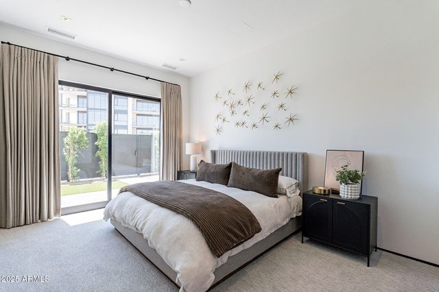 a bedroom with a large bed and a window