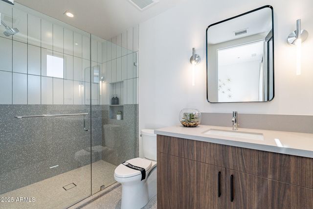 a bathroom with a sink toilet and shower