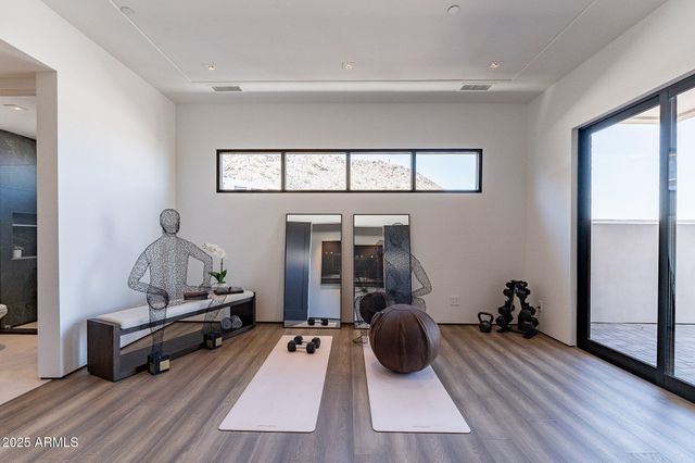 a living room with furniture gym equipment and a window