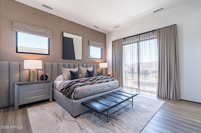 a bed room with a bed and a chair