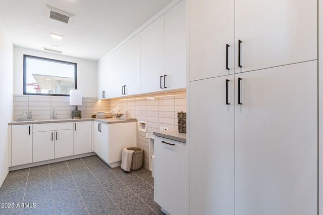 a kitchen with cabinets and window