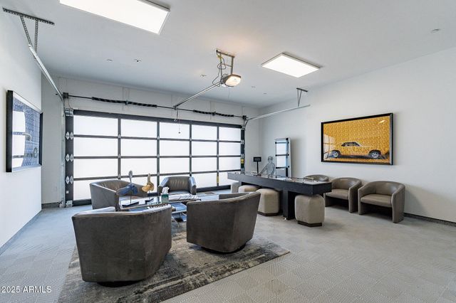 a living room with furniture a window and a flat screen tv