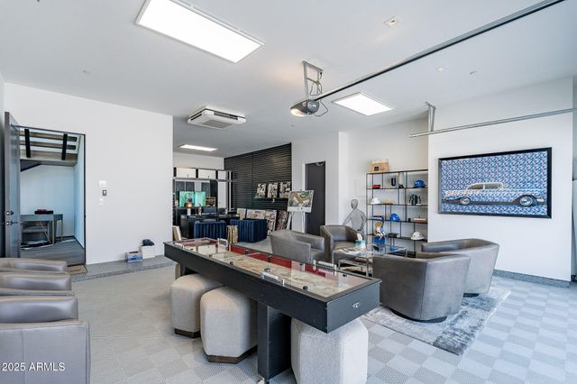 a living room with furniture and a book shelf