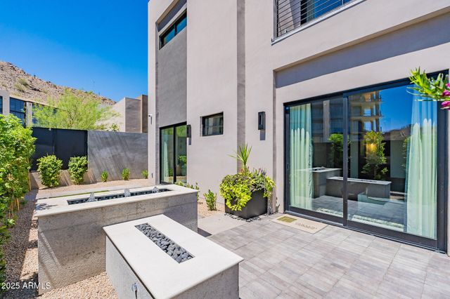 a view of a dinning tables and chairs in front of the house