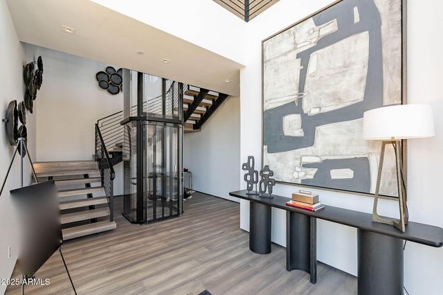 a view of entryway and hall with wooden floor