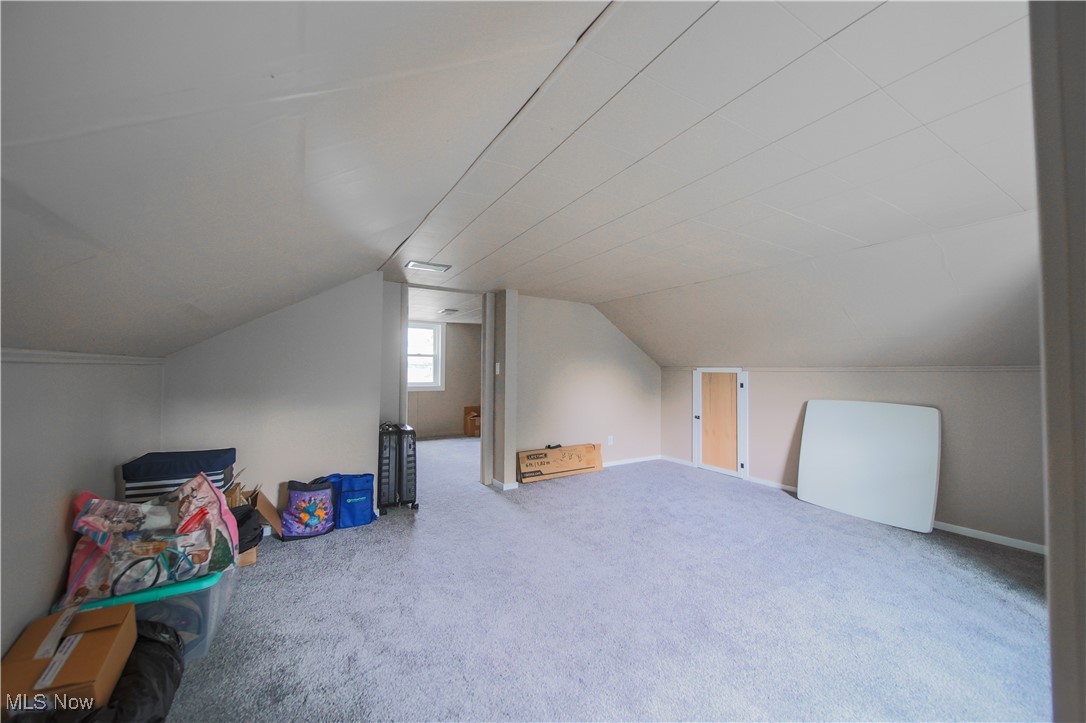 3181 Dover Road Wooster, OH 44691 - Photo 17 of 25 Additional living space with carpet flooring and vaulted ceiling