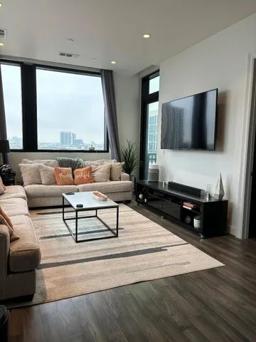 a living room with furniture and a flat screen tv