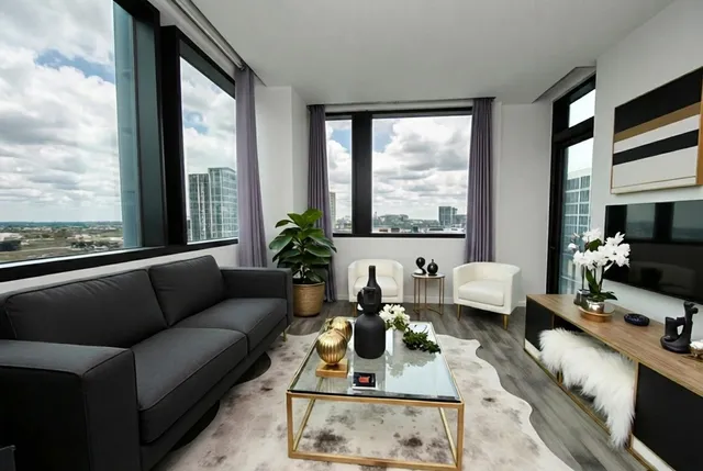 a living room with furniture and a large window