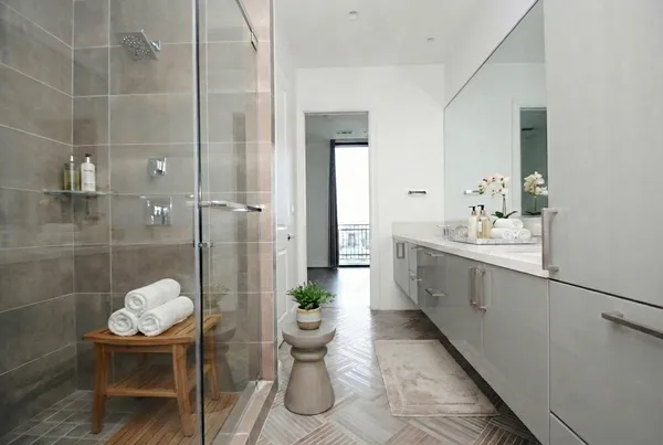 a bathroom with a granite countertop sink a toilet and shower
