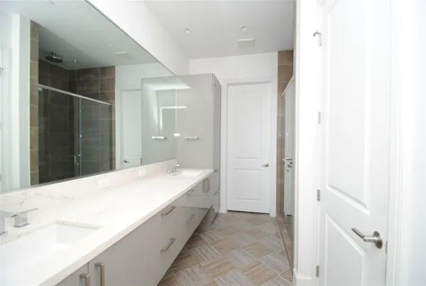 a spacious bathroom with a bathtub and a sink