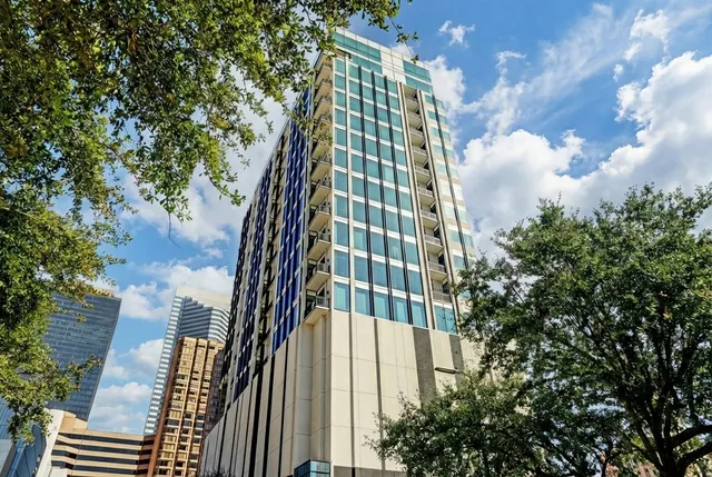 a front view of a multi story building with yard