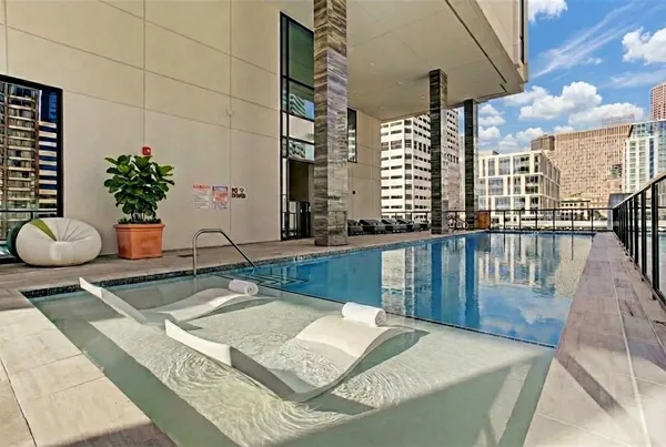 a room with pool table and windows