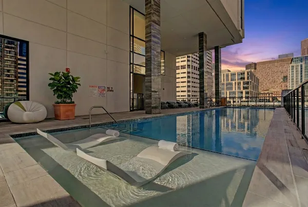 a swimming pool with outdoor seating and yard