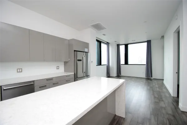 a kitchen with a wooden floor and window