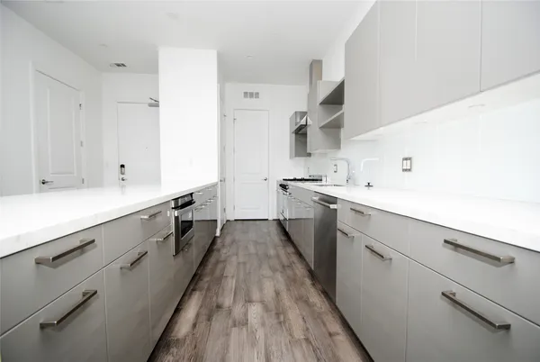a kitchen with a sink stove and cabinets