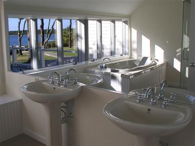 Undisclosed Address Cotuit, MA 02635 - Photo 6 of 7 a bathroom with a sink and a large window
