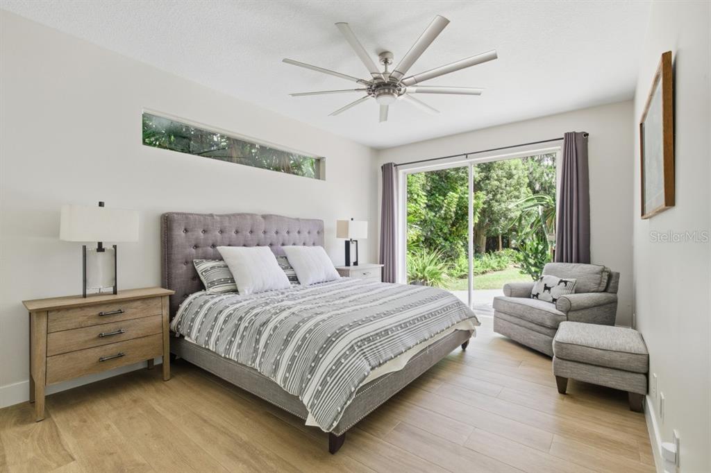 4733 Chuluota Road Orlando, FL 32820 - Photo 21 of 46 a bedroom with a bed couches and a flat tv screen