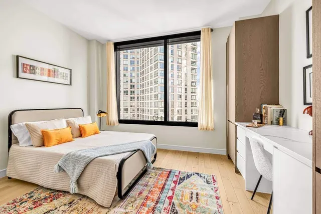 a picture of a bench in front of a wall