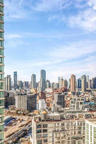 a white kitchen with a sink and a refrigerator