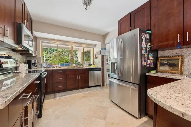 a kitchen with a refrigerator and a stove