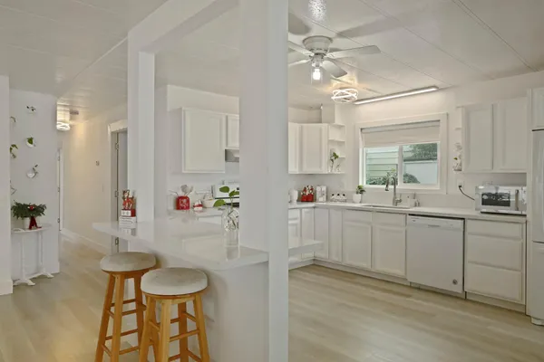a kitchen with sink cabinets and dining table