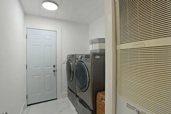 a utility room with dryer and washer