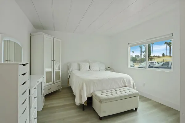 a spacious bedroom with a bed and a window