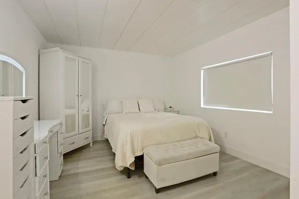 a bedroom with a bed and a night stand