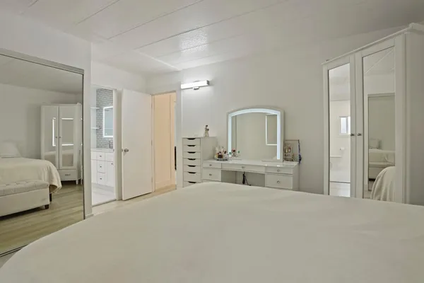 a bedroom with a bed and a mirror