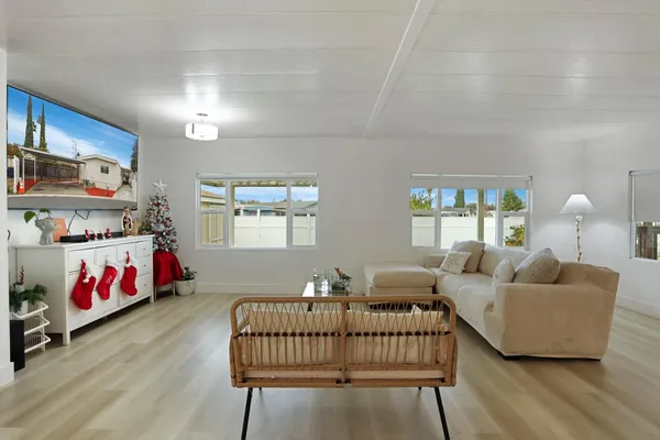a bedroom with furniture and wooden floor