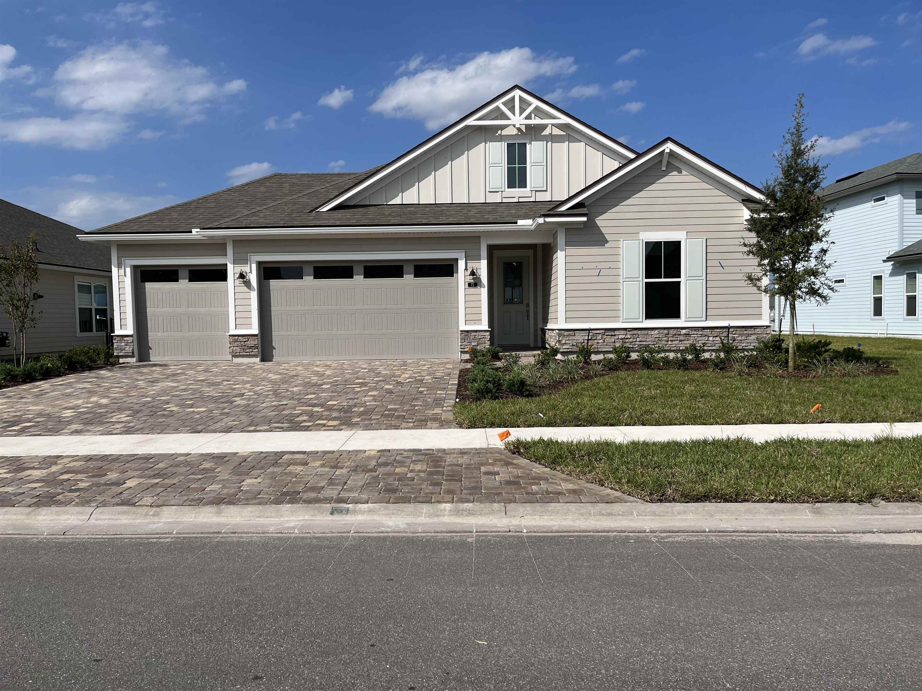 a front view of a house with a garden and plants