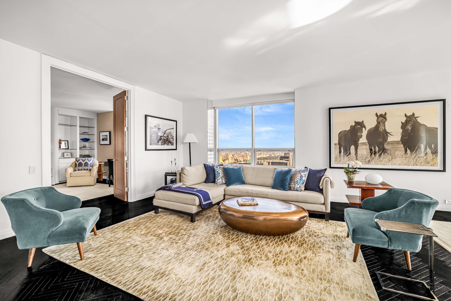 15 West 53rd Street, Unit 46AF Manhattan, NY 10019 - Photo 4 of 17 a living room with furniture and wooden floor