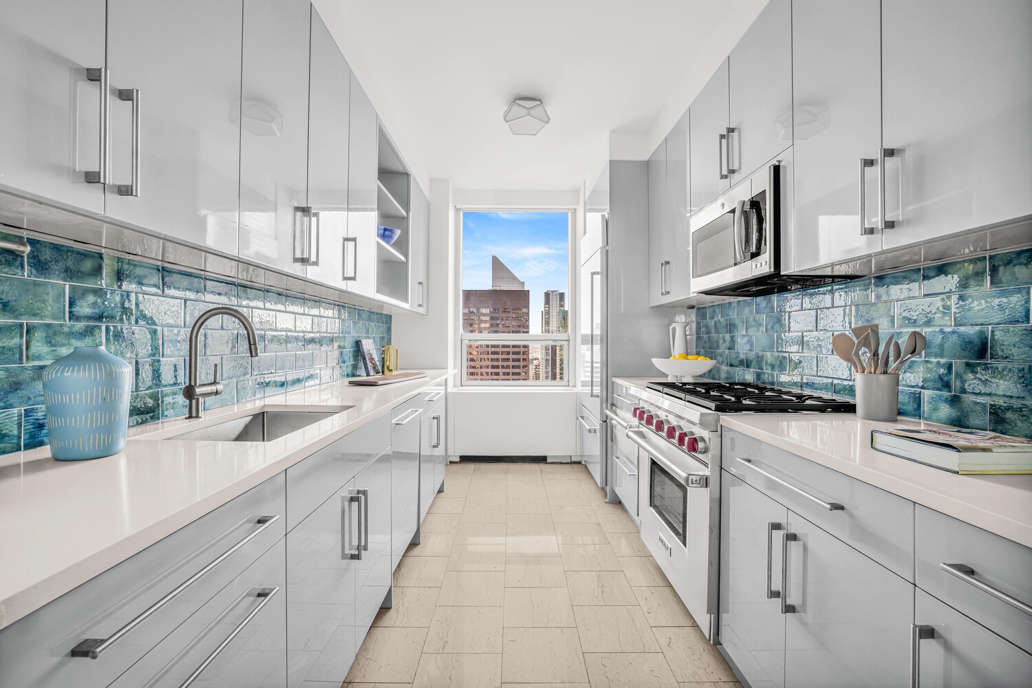 15 West 53rd Street, Unit 46AF Manhattan, NY 10019 - Photo 7 of 17 a kitchen with stainless steel appliances granite countertop a sink stove and cabinets