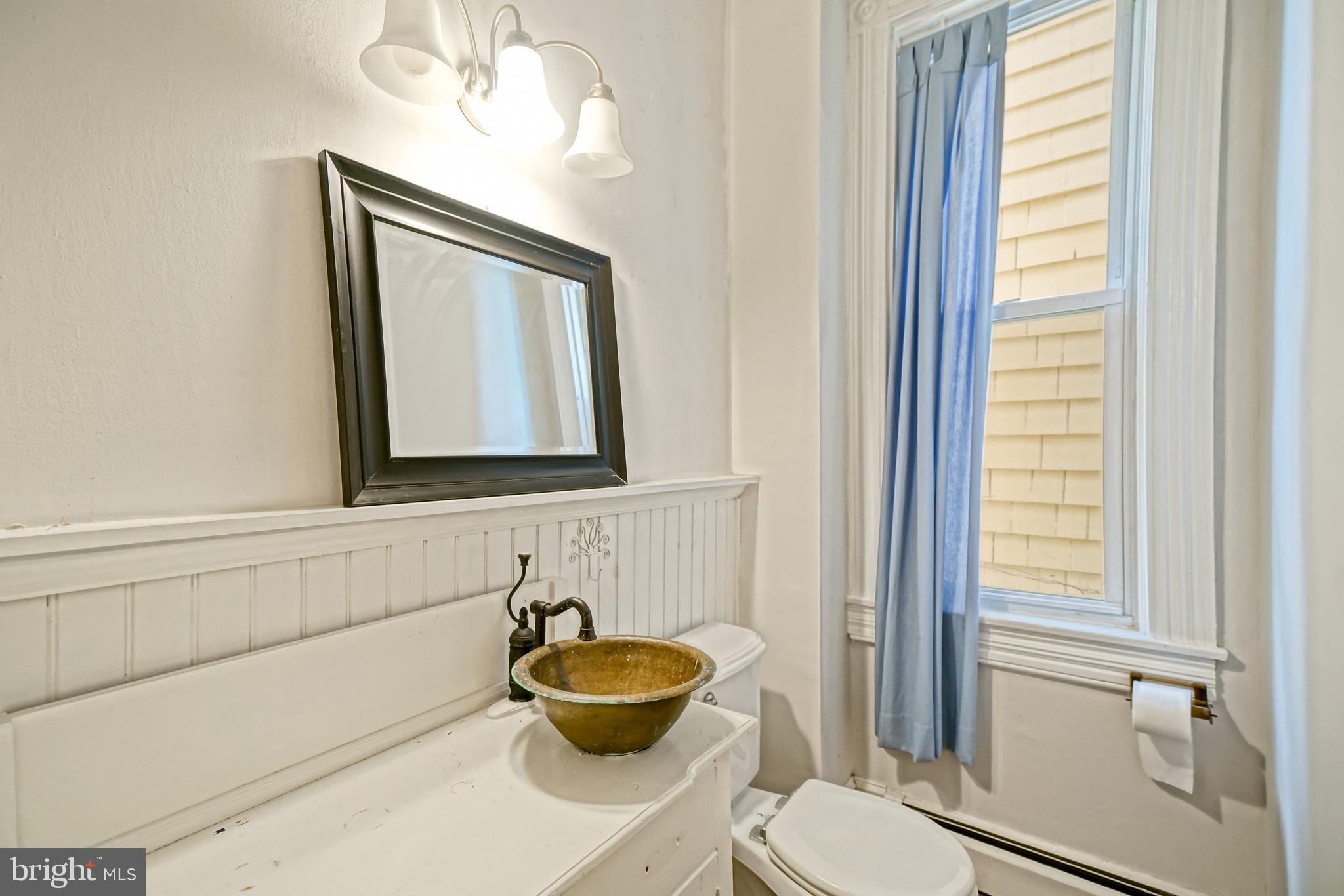407 Savannah Road Lewes, DE 19958 - Photo 15 of 44 a bathroom with a toilet a sink and window