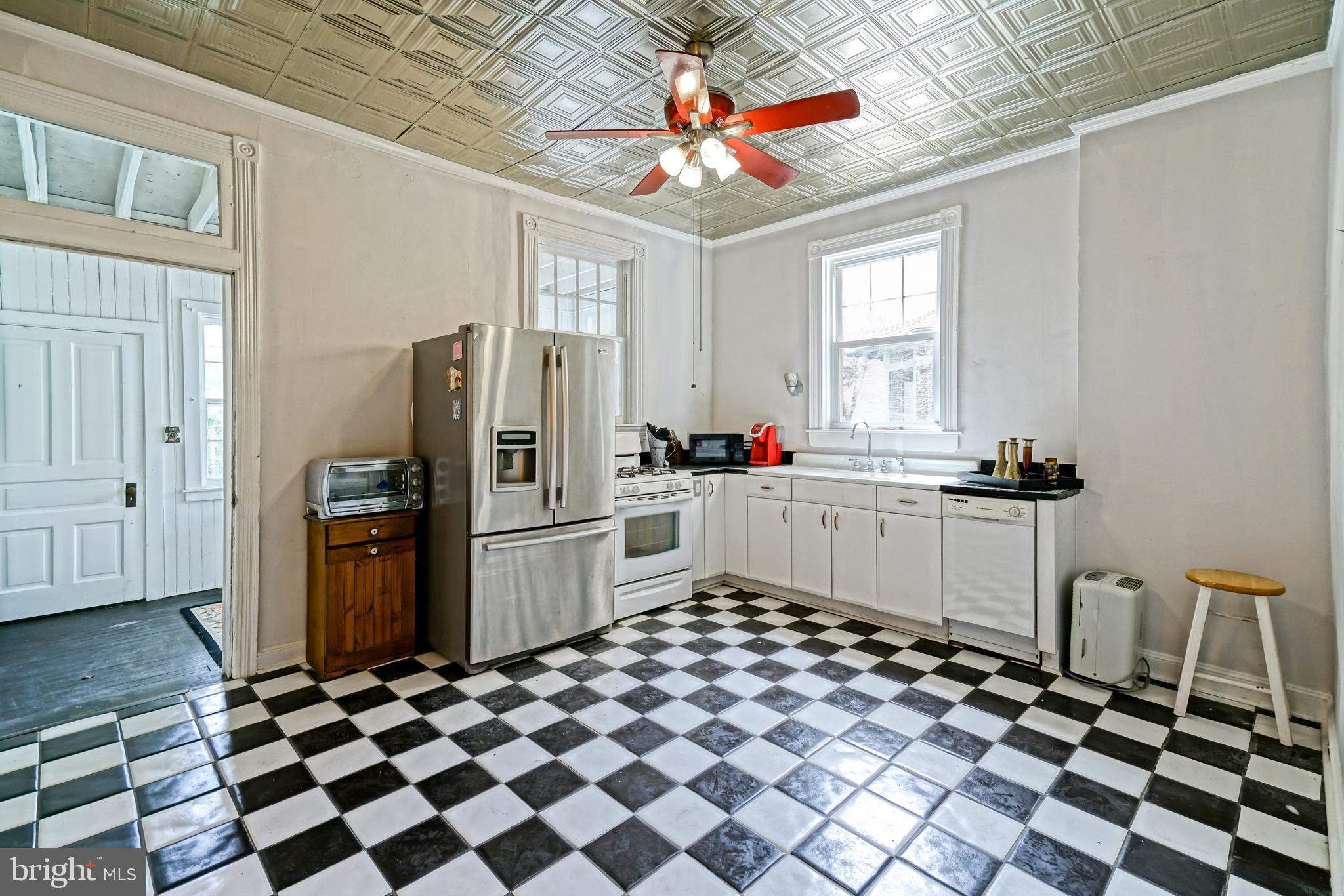 407 Savannah Road Lewes, DE 19958 - Photo 16 of 44 a kitchen with a sink a refrigerator and cabinets