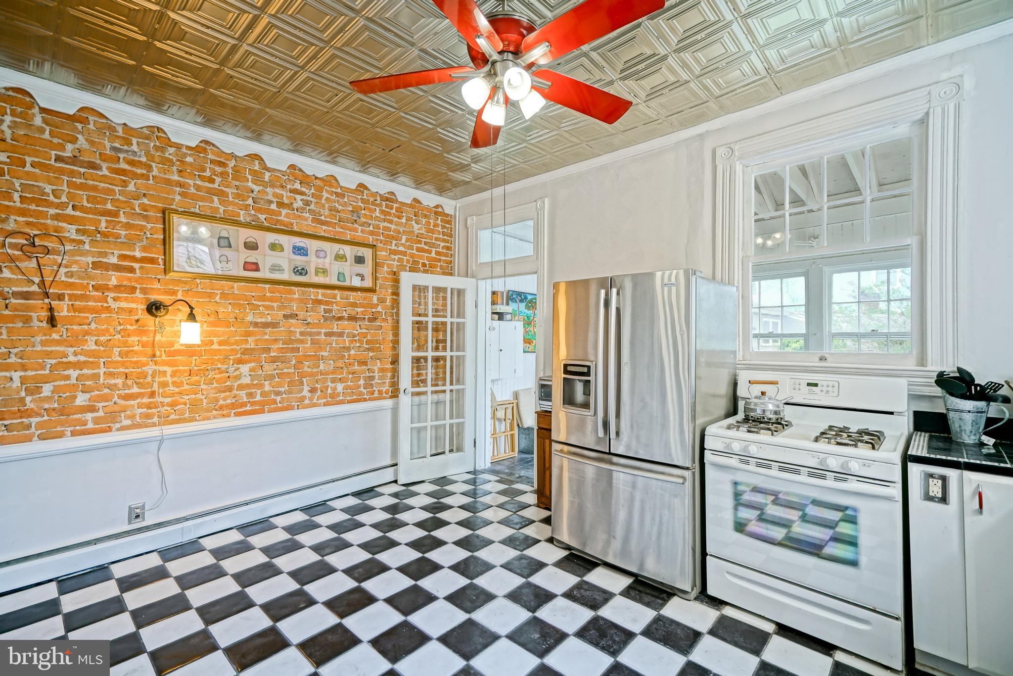 407 Savannah Road Lewes, DE 19958 - Photo 18 of 44 a kitchen with stainless steel appliances a refrigerator and a stove top oven