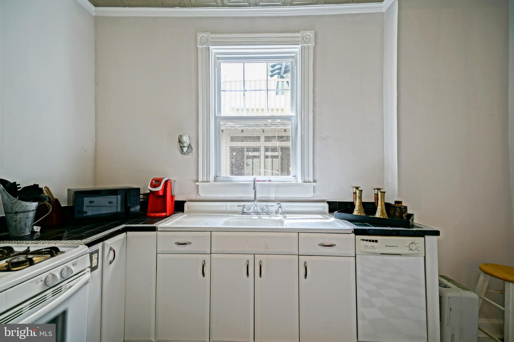 407 Savannah Road Lewes, DE 19958 - Photo 21 of 44 a kitchen with a sink cabinets and window