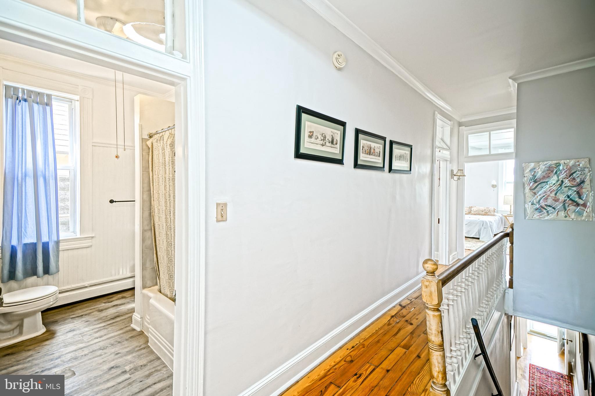 407 Savannah Road Lewes, DE 19958 - Photo 29 of 44 a view of a hallway with wooden floor and staircase