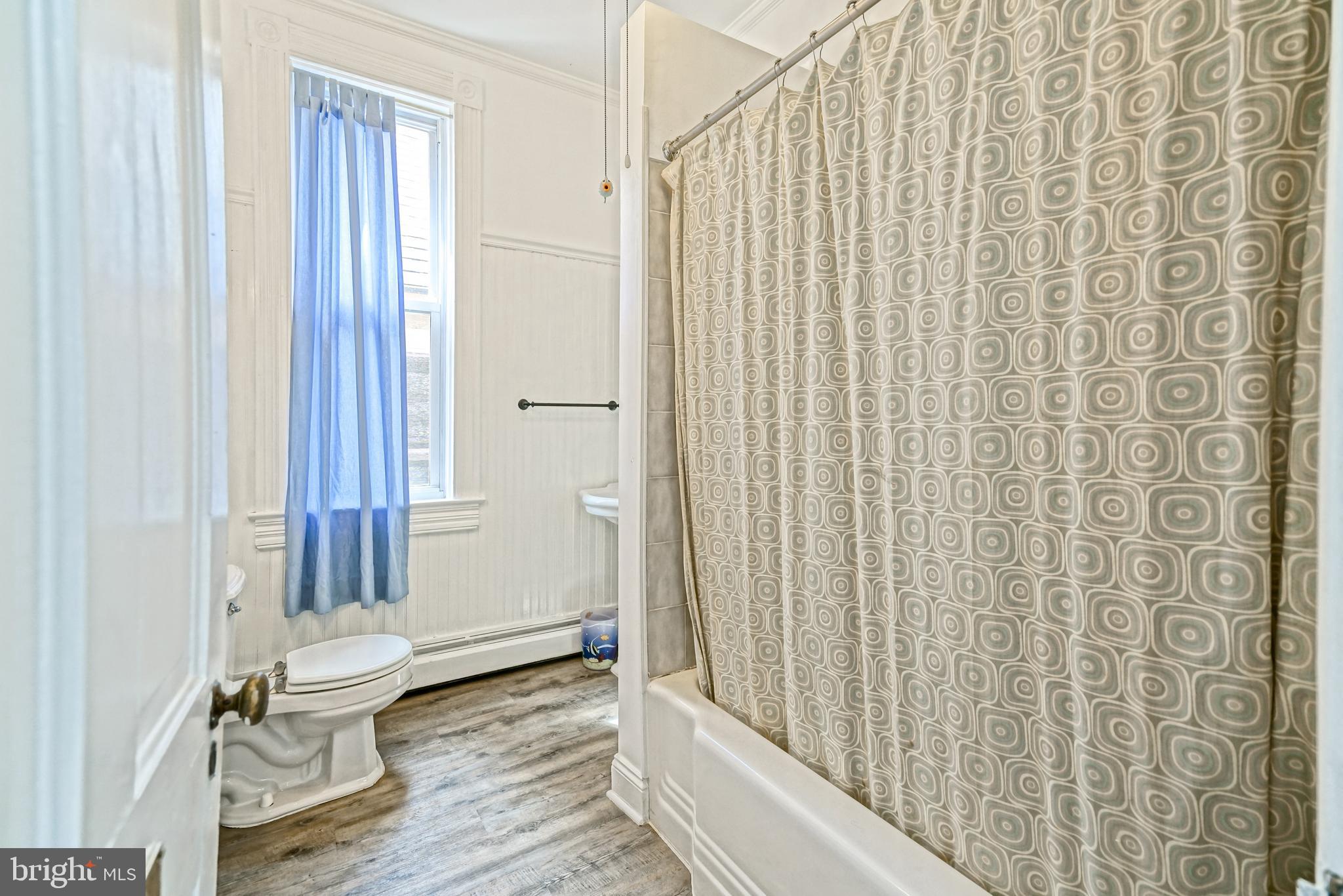 407 Savannah Road Lewes, DE 19958 - Photo 30 of 44 a bathroom with a toilet and a shower curtain