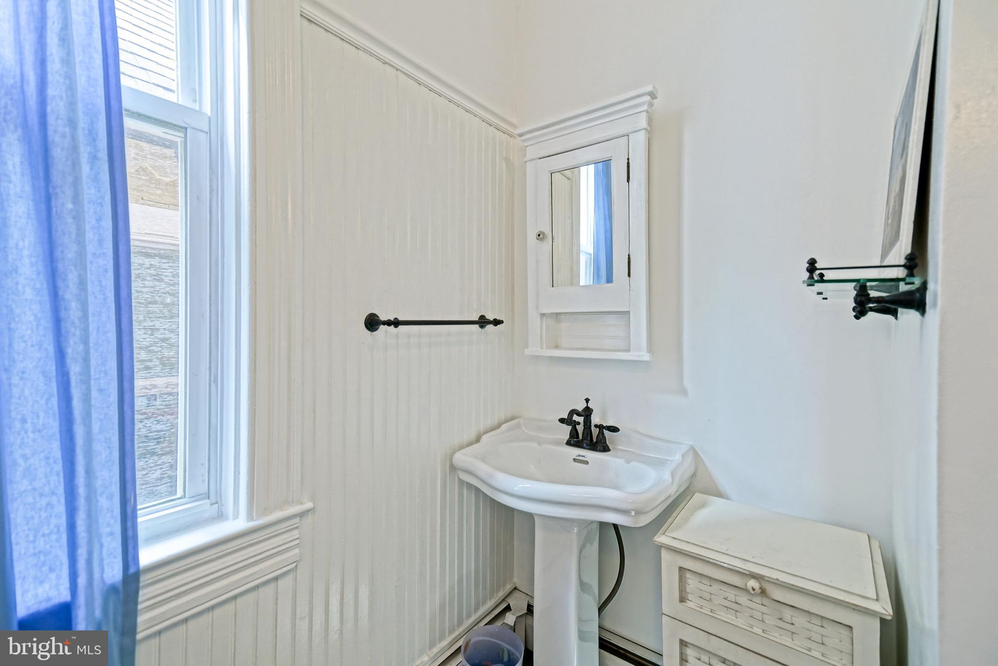 407 Savannah Road Lewes, DE 19958 - Photo 31 of 44 a bathroom with a sink a toilet and a mirror